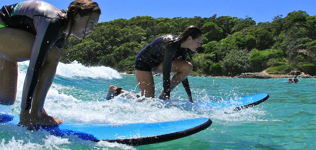 Surfing Catching Waves in Waist Deep Water